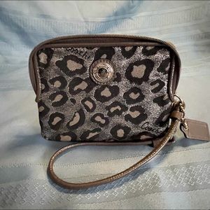 Small coach wristlet. Used in good condition. Grey black and silver